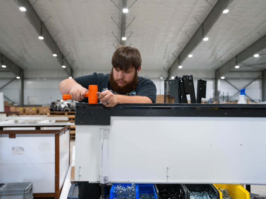 Employee positioning part for roll-up door panel