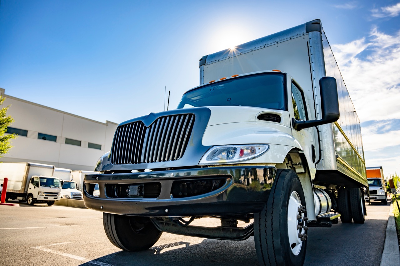 Front view of roll-up box truck parked in lot outside